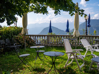 Tables and chairs on a terrace at Mount Sighignola, on the border between Italy and Switzerland,...