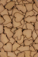 Gingerbread figures for background. Christmas decor. Angel, Christmas tree, pig, heart, man. woman. Vertical