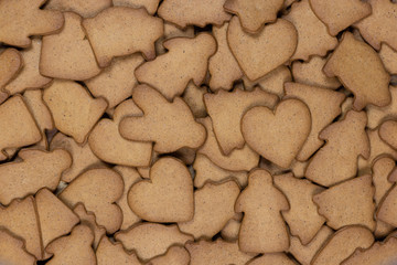 Gingerbread figures for background. Christmas decor. Angel, Christmas tree, pig, heart, man. woman.