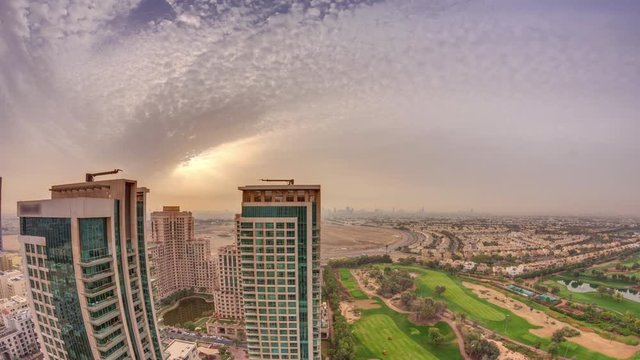 Sunrise over towers in Greens district aerial view from top timelapse. Residential and office buildings from above near golf cource