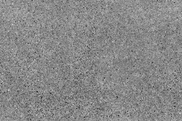  Naadloze asfaltweg achtergrond. Korrelige vloertextuur met grinddeeltjes, kleine stenen, zwarte, grijze en witte korrels. Close-up, bovenaanzicht. Grijs asfaltpatroon. Bitumen wegtextuur © Olgastocker