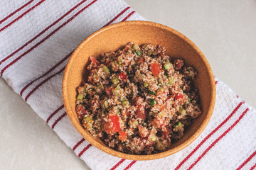 Traditional Arabic Salad Tabbouleh with couscous, vegetables and greens