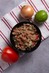 Traditional Arabic Salad Tabbouleh with couscous, vegetables and greens