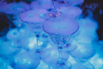 Beautiful tower line of different colored alcohol cocktails wit on a party event, tequila, martini, vodka, and others on decorated catering banquet table