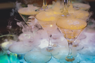 Beautiful tower line of different colored alcohol cocktails wit on a party event, tequila, martini, vodka, and others on decorated catering banquet table