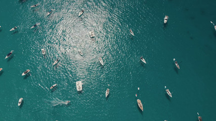 Aerial View of many yachts in a bay on Formentera island. Cala Saona bay drone footage. Yachting in...