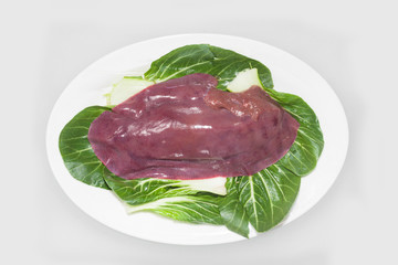 Fresh liver is served on a white China plate