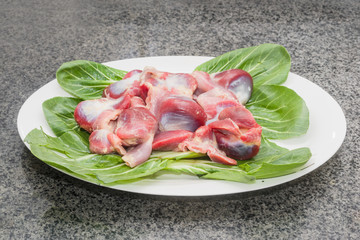 Fresh chicken gizzards are served in white China dishes