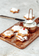 Homemade Christmas star shape gingerbread cookies with cheese cream