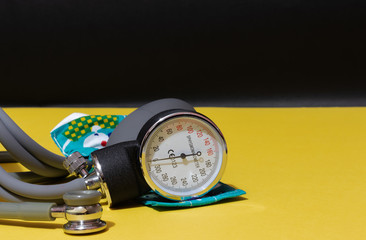 Pediatrics sphygmomanometer on yellow with black background, children and newborn blood pressure...