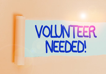 Handwriting text Volunteer Needed. Conceptual photo asking demonstrating to work for organization without being paid Cardboard which is torn in the middle placed above a plain table backdrop