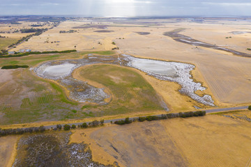 A large fresh water dam on Hindmarsh Island south of Adelaide in Australia that is dry due to drought and full of salt