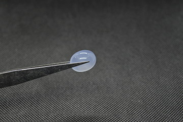 Natural Chalcedony on a vise on black fabric background.