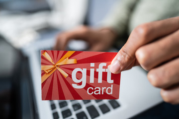 Man Holding Red Gift Card