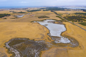 A large fresh water dam on Hindmarsh Island south of Adelaide in Australia that is dry due to drought and full of salt