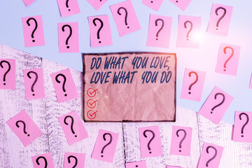 Writing note showing Do What You Love Love What You Do. Business concept for Pursue your dreams or passions in life Scribbled and crumbling papers with thick cardboard above wooden table