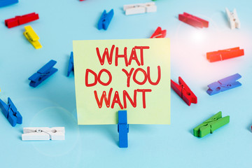 Word writing text What Do You Want. Business photo showcasing used for offering something to someone or asking their need Colored clothespin papers empty reminder blue floor background office pin