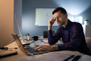Stressed Accountant Working Late In Office
