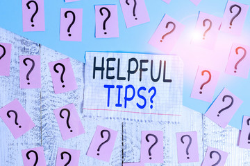 Conceptual hand writing showing Helpful Tips Question. Concept meaning secret information or advice given to be helpful knowledge Crumbling papers with thick cardboard on the wooden table