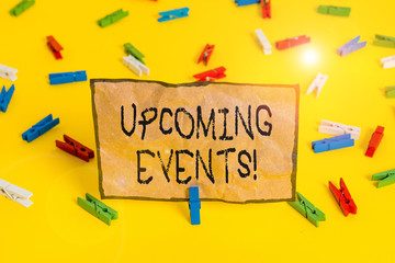 Handwriting text writing Upcoming Events. Conceptual photo thing that will happens or takes place soon planned occasion Colored clothespin papers empty reminder yellow floor background office