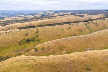 Rolling green hills and trees in farmland south of Adelaide in Australia