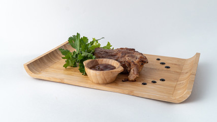 meat on a wooden board with herbs and spices
