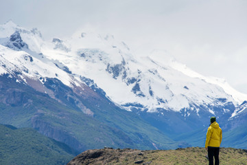 Fototapeta na wymiar A hiker man looks over the mountains in El Chalten, Patagonia, Argentina