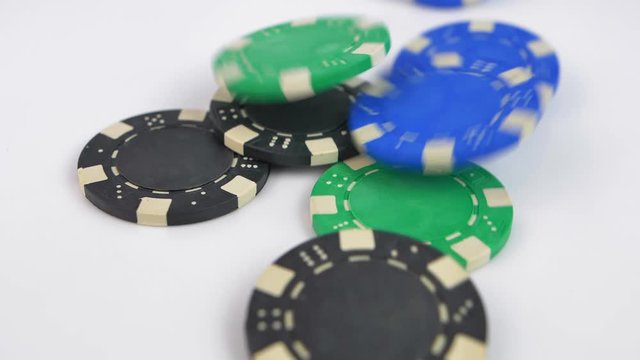 Poker Chips Thrown at White Table Slow Motion