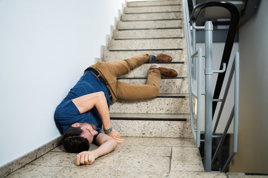 Unconscious Man Lying On Staircase