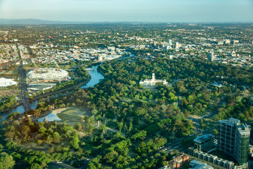 Melbourne, Australia - November 17, 2009: Aerial view on white Government House with tower and flag with surrounding botanical gardens. Wide veiw over eastern suburbs and Yarra river.