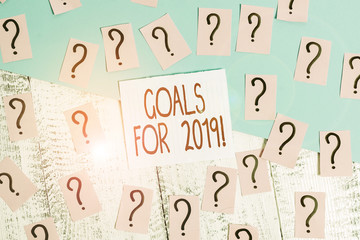 Word writing text Goals For 2019. Business photo showcasing object of demonstratings ambition or effort aim or desired result Scribbled and crumbling papers with thick cardboard above wooden table