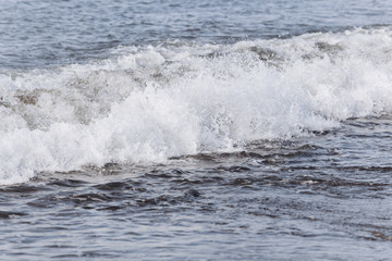 Waves on the beach. A surge of water ashore.