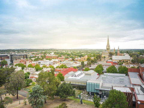 Aerial landscape view of the historic town Bendigo. Buildings and old church in town, and residential houses in distance. VIC Australia.