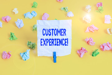 Writing note showing Customer Experience. Business concept for product of interaction between organization and buyer Colored crumpled paper empty reminder white floor clothespin