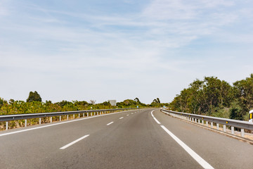Fototapeta premium Paved road and beautiful green landscape in summer