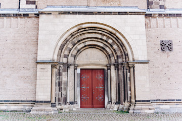 Beautiful doors in the Romanesque style with a big arch.