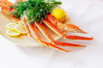 Crab, lemon and dill on a plate on a white background.