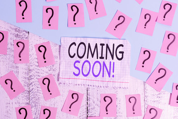 Conceptual hand writing showing Coming Soon. Concept meaning event or action that will happen after really short time Crumbling papers with thick cardboard on the wooden table