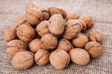 Mature walnuts on woven fabric. Nuts on linen fabric