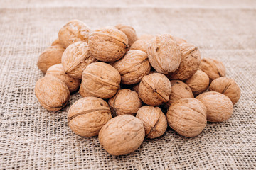 Mature walnuts on woven fabric. Nuts on linen fabric