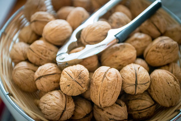 Nutcracker on brown walnuts. Whole walnuts