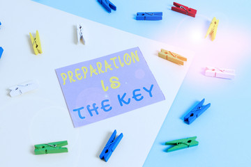 Conceptual hand writing showing Preparation Is The Key. Concept meaning it reduces errors and shortens the activities Colored clothespin paper reminder with yellowblue background