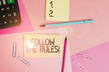 Text sign showing Follow The Rules. Business photo text go with regulations governing conduct or procedure writing equipments with stationary and plain note paper placed on the table