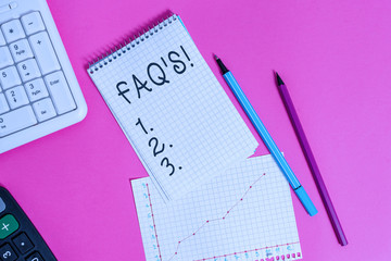 Handwriting text Faq. Conceptual photo a list of questions and answers relating to a particular subject Writing equipments and computer stuffs placed above colored plain table
