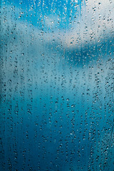 rain drops on window blue background