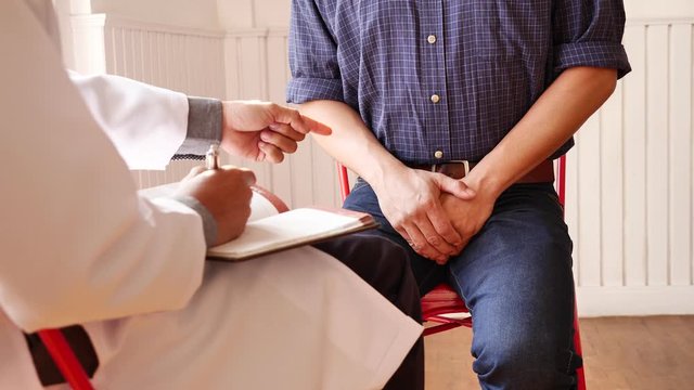 Doctor consulting discussing prostate and venereal cancer detected with patient.