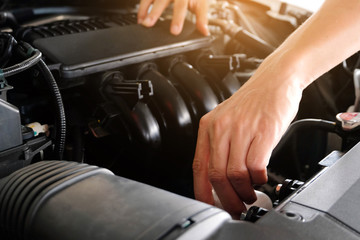 Car maintenance technician He is checking the auto engine, car inspection center.
