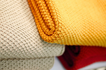 Red, beige and yellow knitted blankets