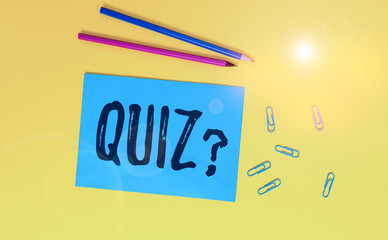 Conceptual hand writing showing Quiz Question. Concept meaning test of knowledge as competition between individuals or teams Blank paper sheet message reminder pencils clip colored background