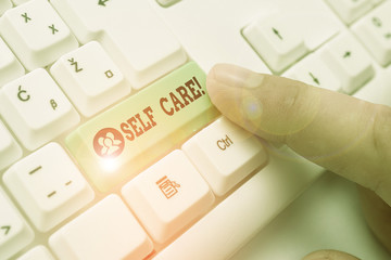 Writing note showing Self Care. Business concept for the practice of taking action to improve one s...